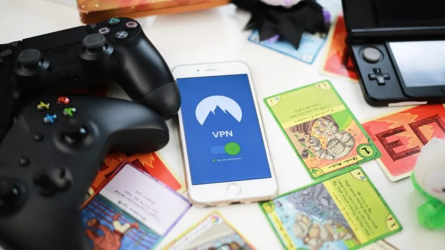 A gamer's hands holding a smartphone with an external game controller during an intense mobile gaming session