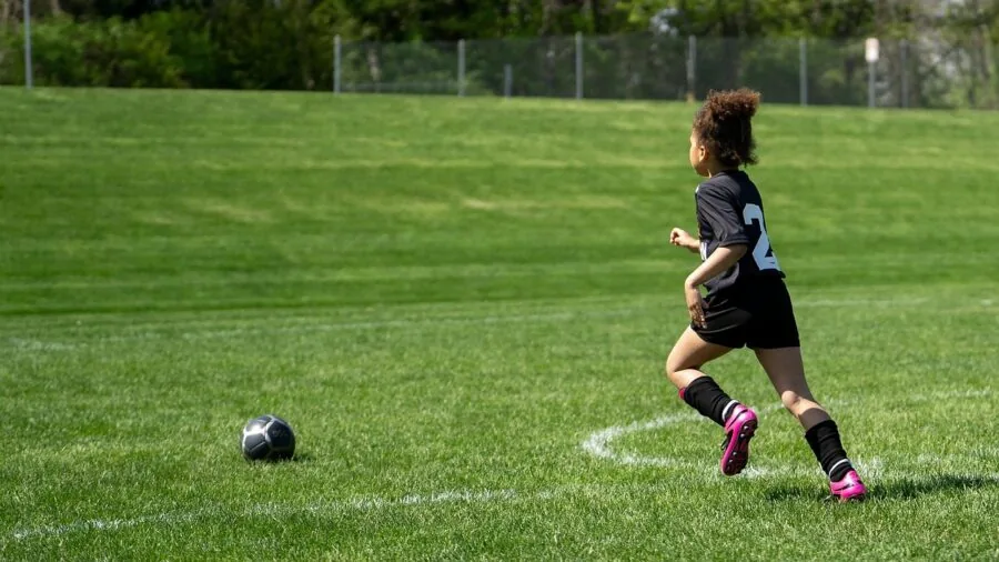 Active child running outside during physical activity and exercise