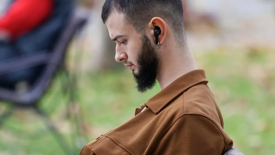Active person enjoying wireless earbuds during outdoor workout or run