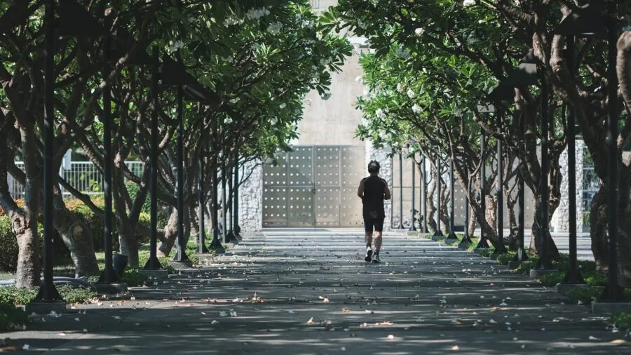 Active person running outdoors while tracking fitness metrics and heart rate during exercise