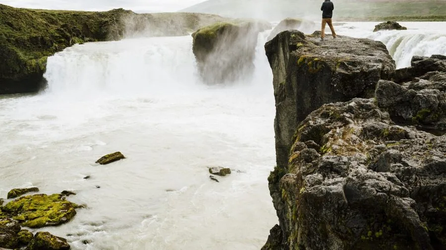 Active traveler navigating challenging outdoor environment with camera gear in natural conditions