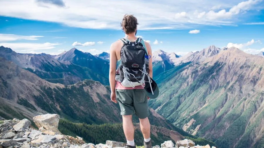 Adventurer reviewing action camera footage on touchscreen display in outdoor setting