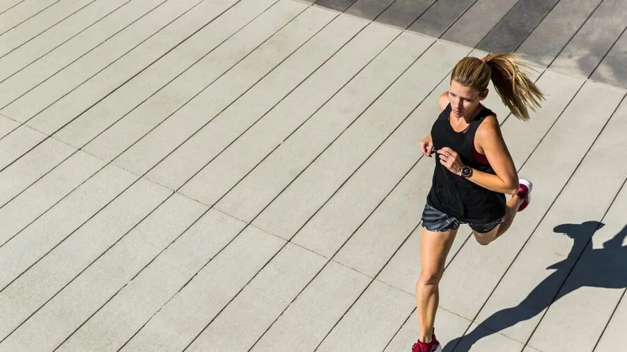 Athlete running outdoors during fitness training session in natural daylight