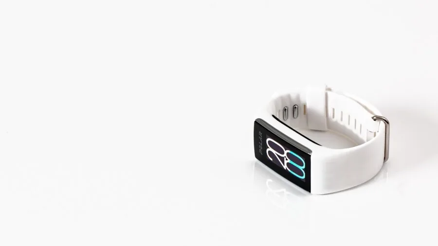 Athlete wearing fitness wearable device while swimming in pool water