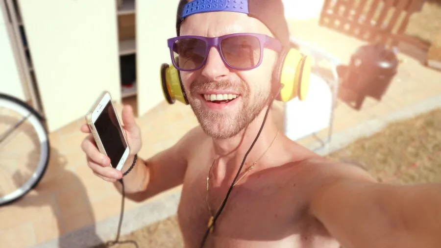 Athlete wearing headphones during intense workout session, focused on fitness training