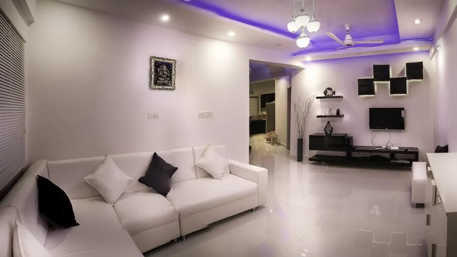 Bright minimalist living room with clean hardwood floors and organized furniture layout