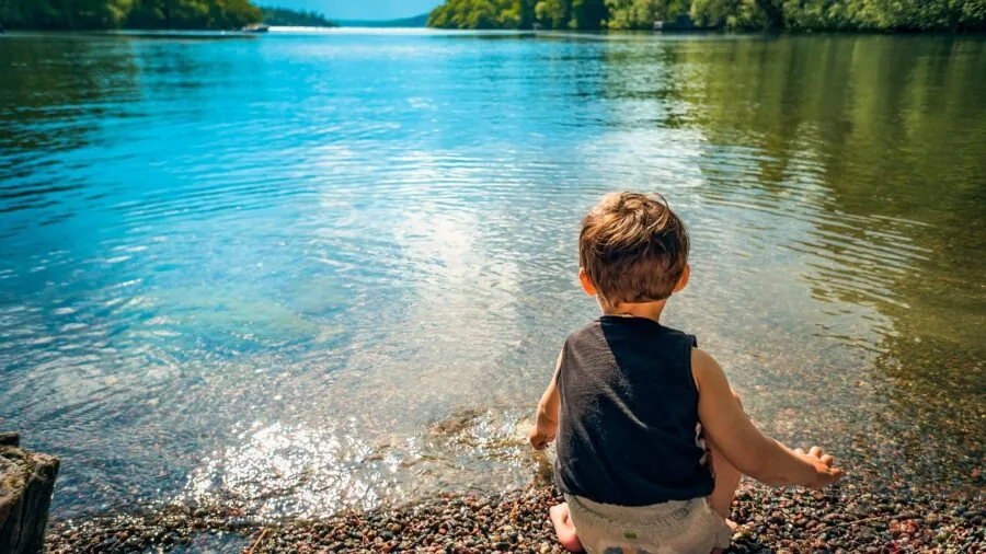 Child enjoying water activities at beach during summer vacation
