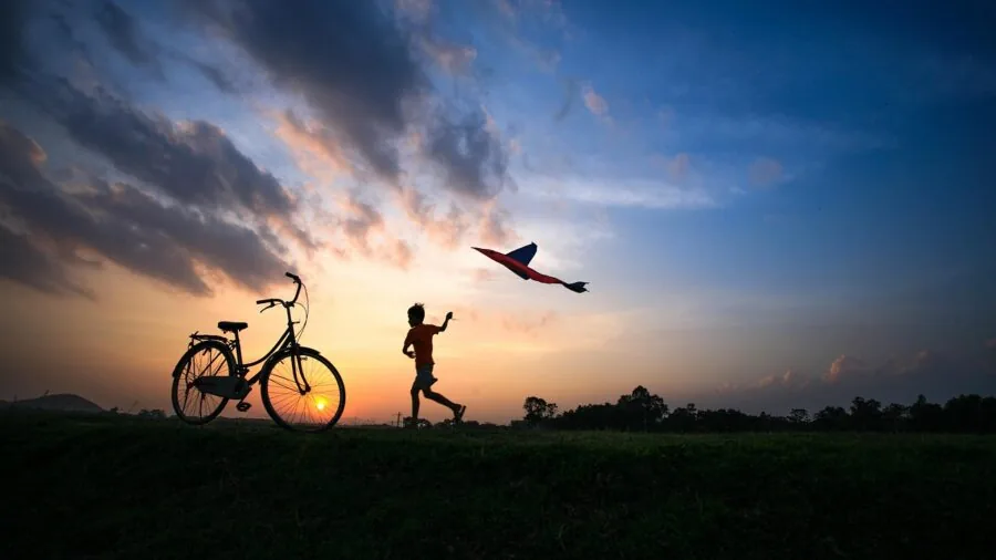 Child wearing fitness tracker while playing outdoors in natural daylight