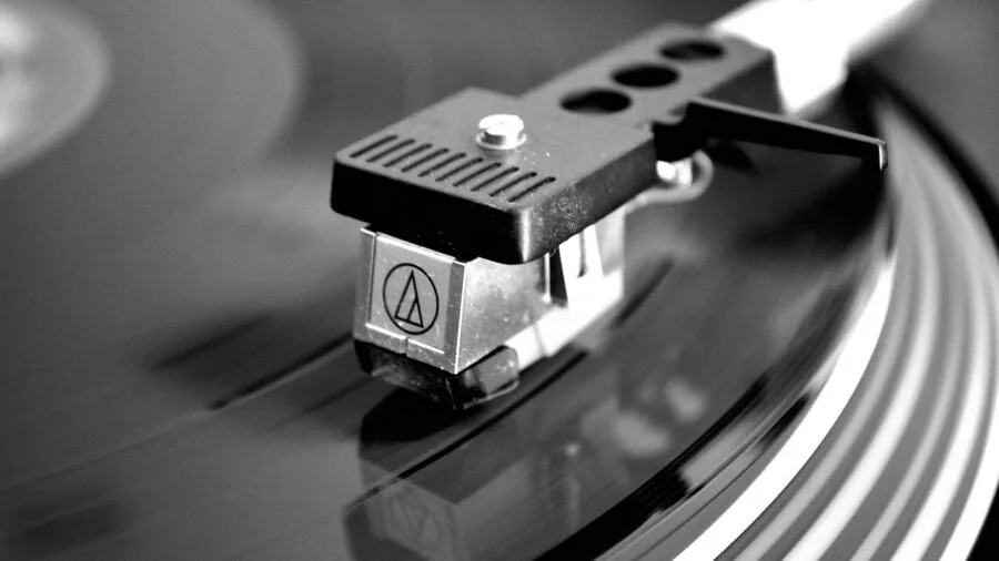 Close-up of a spinning vinyl record on a turntable platter during playback