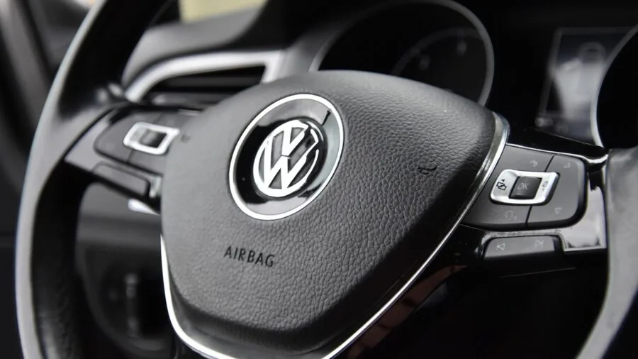 Close-up of hands firmly gripping a leather-wrapped steering wheel during an intense driving session