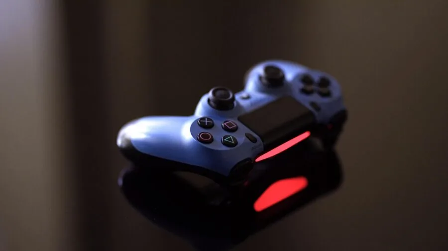 Close-up of hands holding game controller during gaming session, showing joystick detail