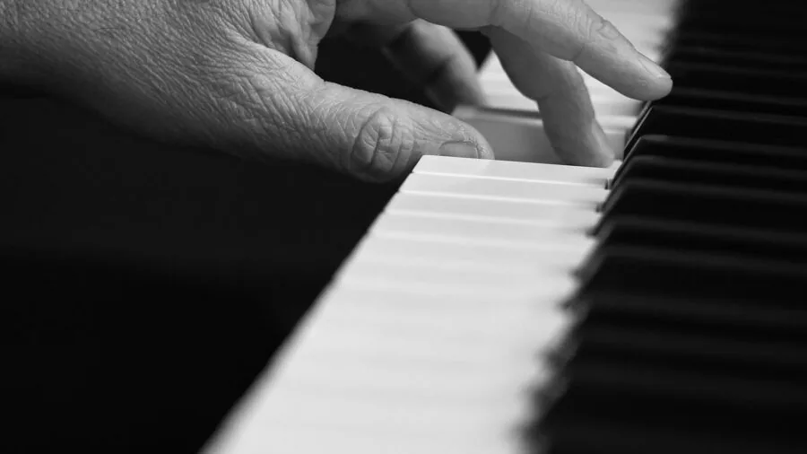 Close-up of hands typing on mechanical keyboard during intense gaming session
