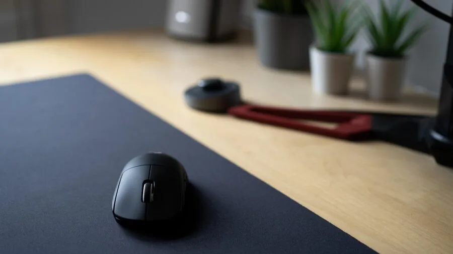 Close-up of hands using gaming mouse during competitive gameplay session