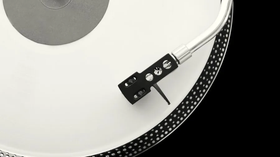 Close-up of turntable stylus touching spinning vinyl record during playback