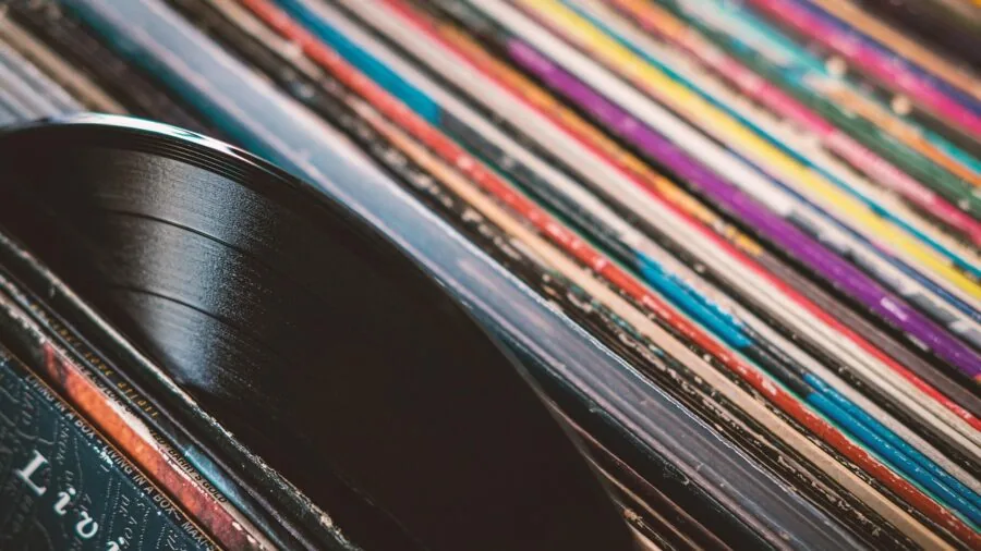 Close-up of turntable stylus touching vinyl record groove during playback