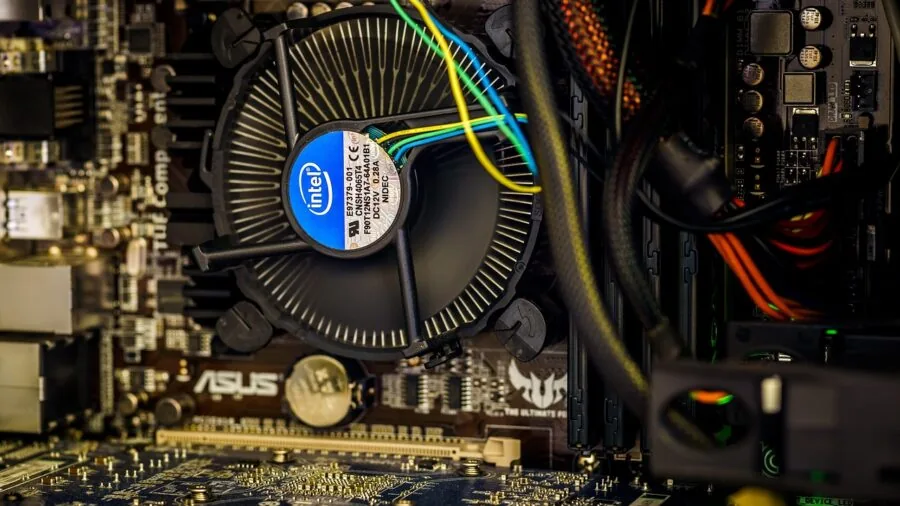 Close-up view of PC cooling fans with blue LED lighting and thermal management components in action