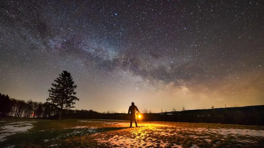 Content creator recording in low-light conditions at night with professional equipment