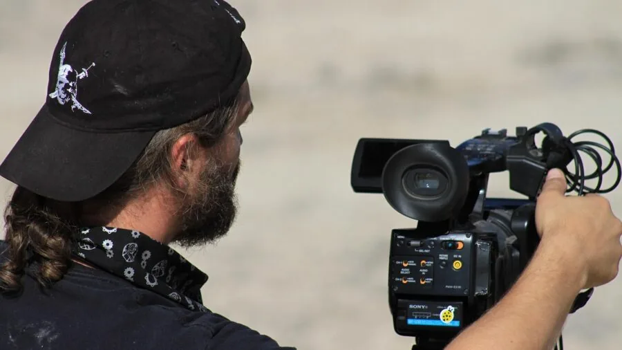Content creator using stabilization equipment to film smooth video footage outdoors