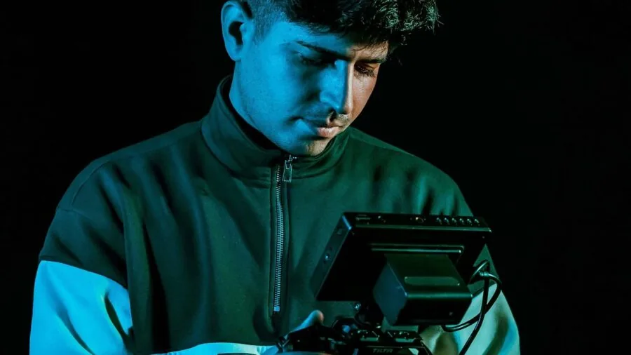 Content creator weighing and inspecting camera gear before outdoor filming shoot