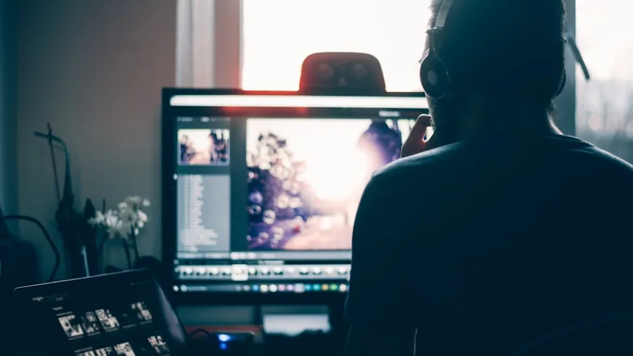 Creative professional editing video content on laptop in modern workspace setup