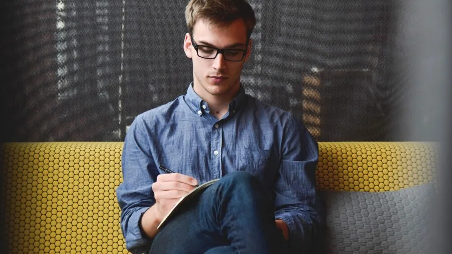 Creative professional sketching wirelessly on tablet from comfortable couch setup