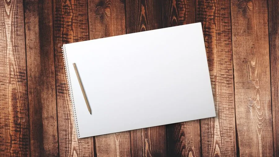 Creative professional working on digital drawing tablet at organized desk workspace