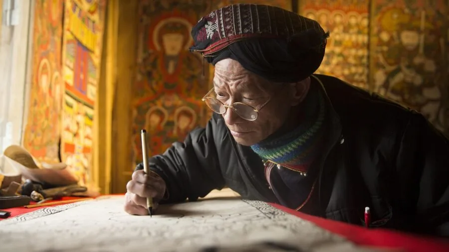 Designer using stylus pen on digital tablet with natural hand positioning and focus