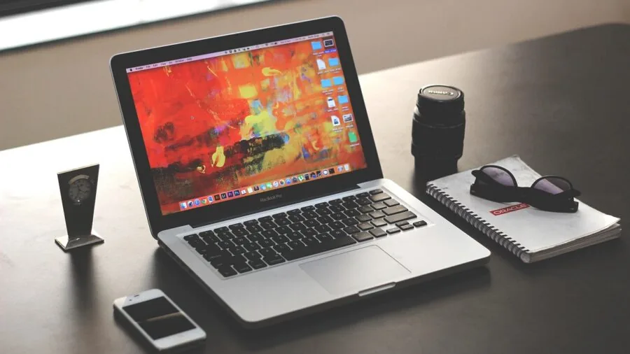 Developer coding at desk with dual monitors in modern home office setup