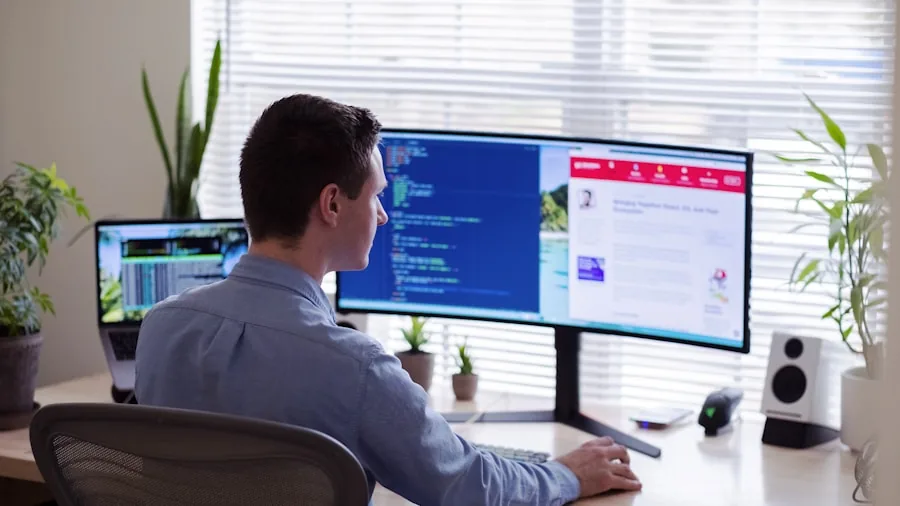 developer coding at desk with multiple displays