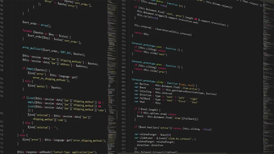 Developer writing code at computer workstation with focused concentration
