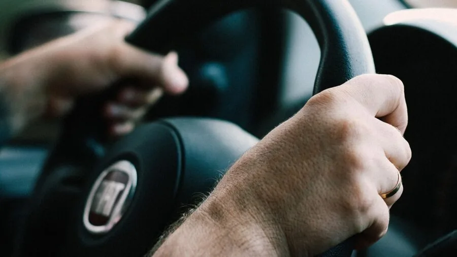 Driver's hands on steering wheel during realistic driving simulation experience
