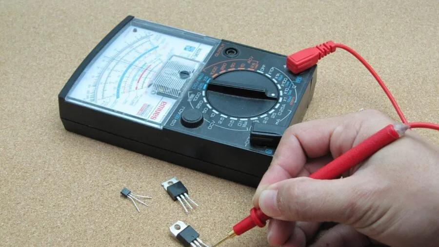 Engineer examining circuit board components in professional workshop setting