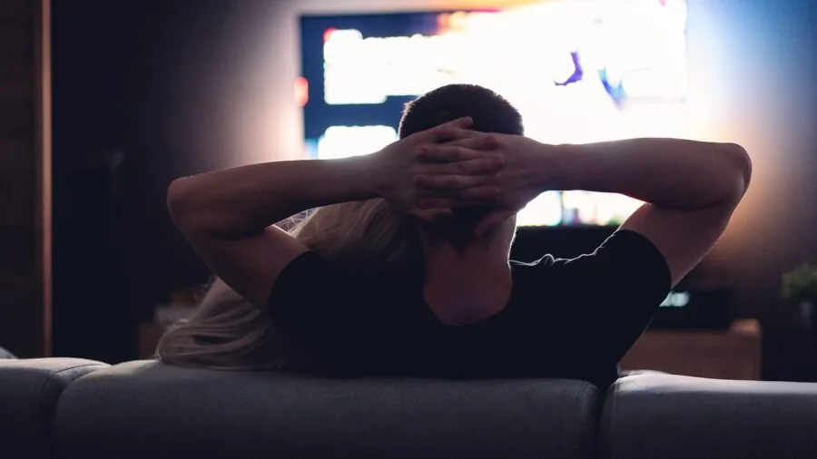 Family enjoying entertainment on large television in modern living room setting