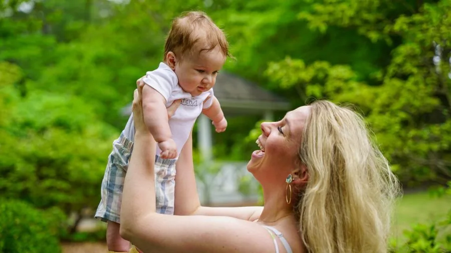 Family members smiling during a video call on a device, showing connection and communication