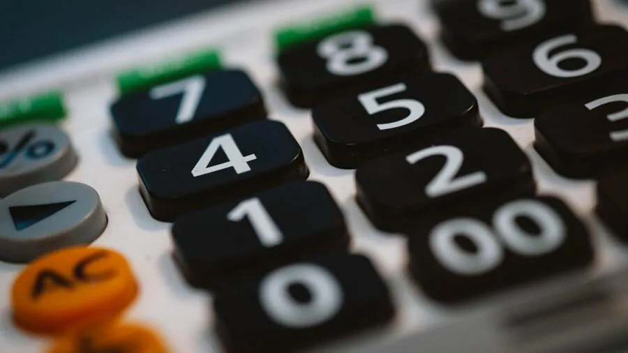Family reviewing financial documents and calculator while planning expenses at home