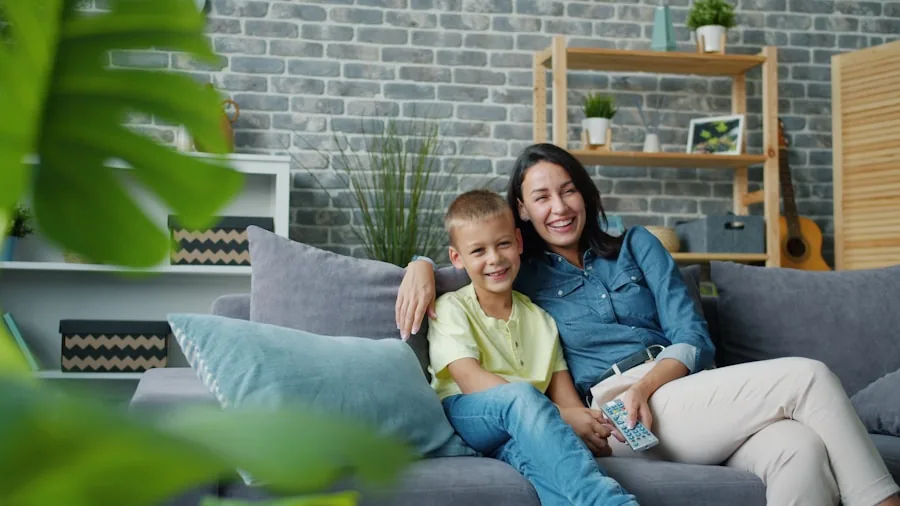 Family sitting on couch watching TV in modern living room with comfortable seating arrangement
