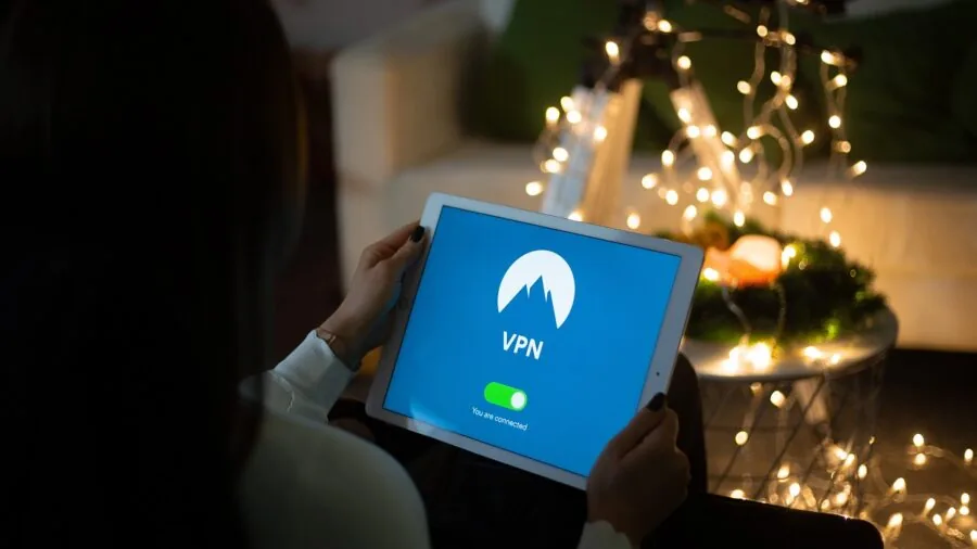 Family using various connected devices simultaneously in a modern living room for streaming and work