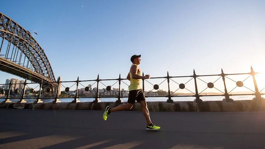 Female runner exercising on sunny path wearing athletic gear during outdoor jog