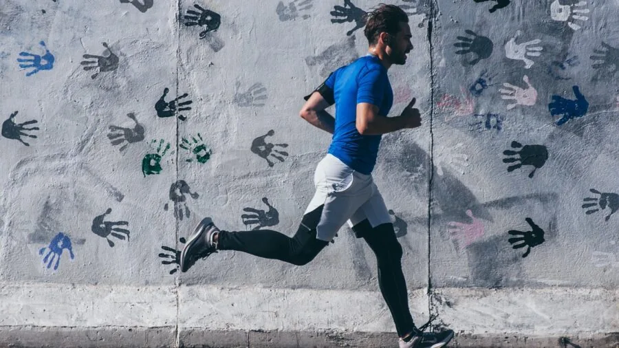 Female runner in motion on outdoor path, demonstrating active movement and athletic performance