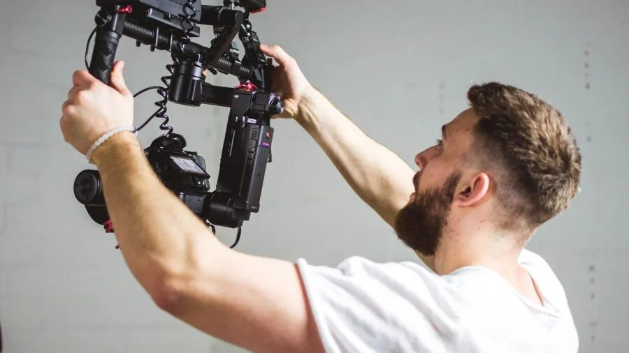 Filmmaker reviewing video footage on camera display in natural lighting environment