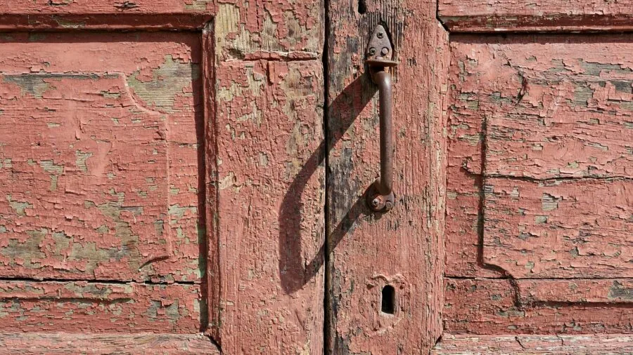 Front door entrance during rainy weather showing outdoor elements and natural wear