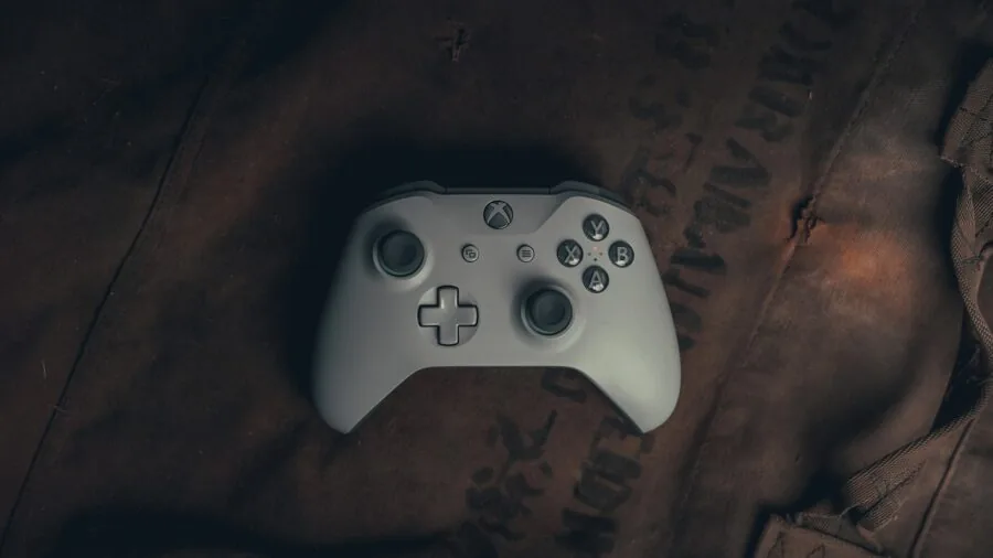 Gamer charging wireless controller during gaming session at home setup