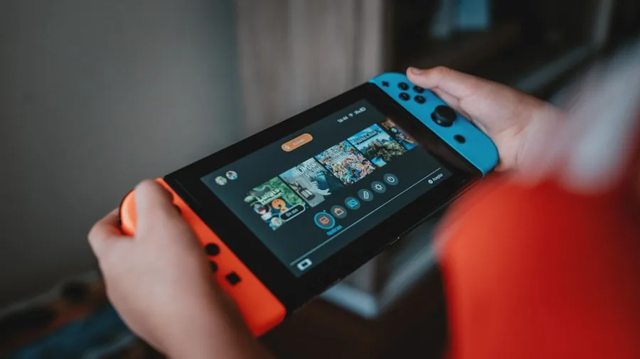 gamer holding portable gaming console