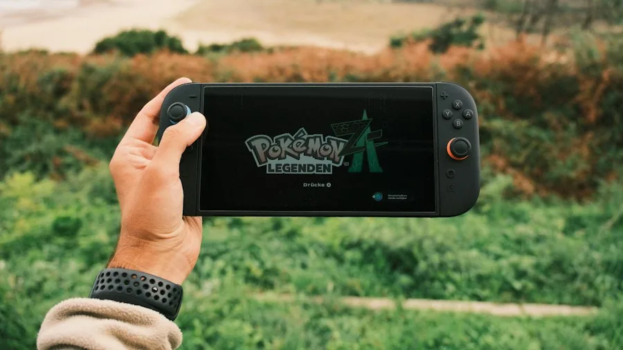 gamer playing handheld device outdoors