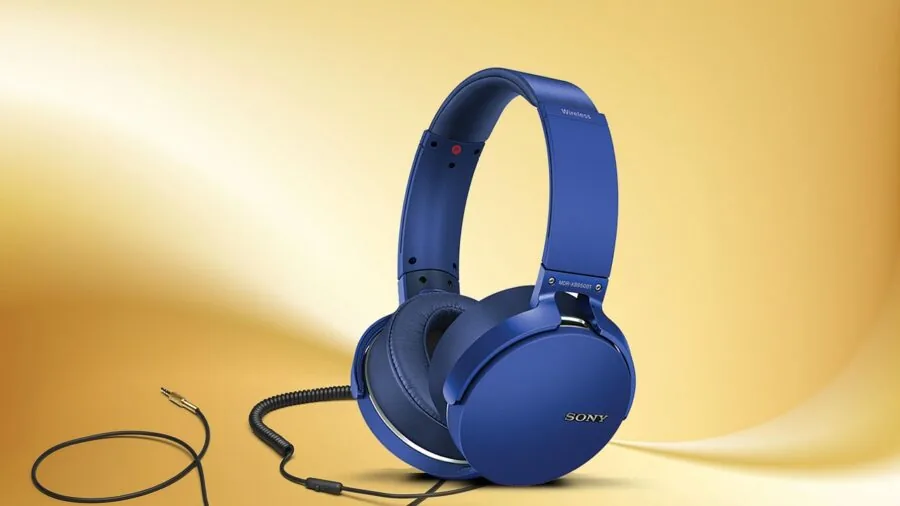 Gamer wearing headphones at computer desk during gaming session