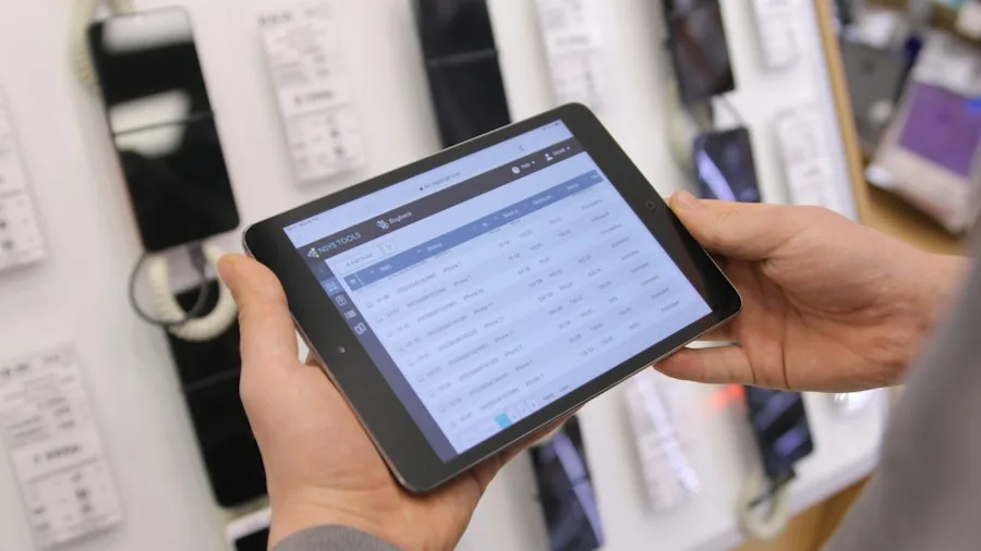 hands holding tablet showing business analytics