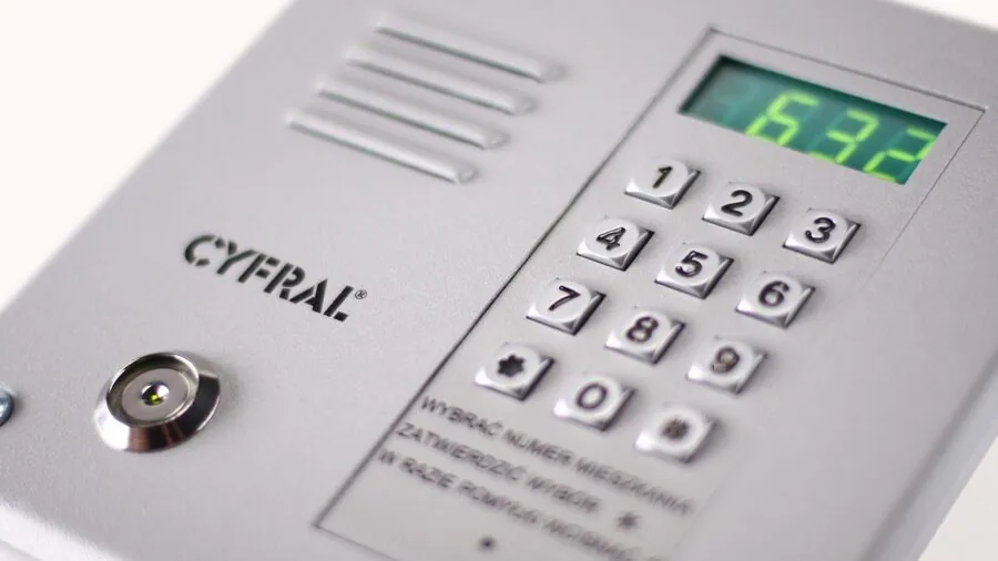 Homeowner communicating through modern doorbell system with visitor outside home entrance