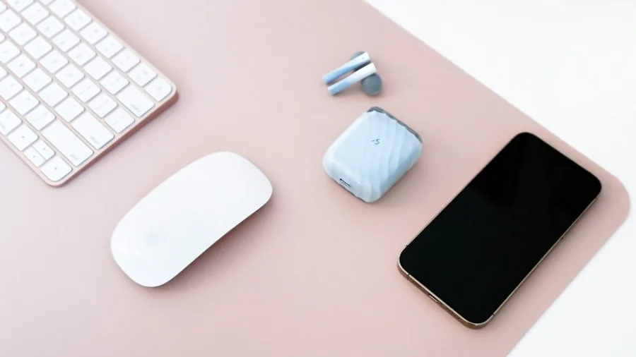 Minimalist desk setup with wireless keyboard and multiple devices for productive typing work