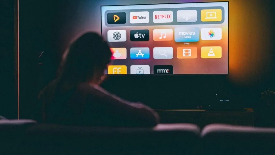 Modern living room with natural light showing home entertainment and streaming setup on wall display