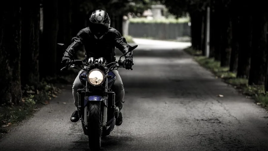 Motorcyclist riding on open highway during extended journey with scenic landscape